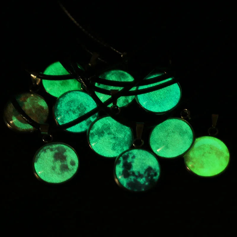 Luminous alloy pendant necklace with Christmas moon, night sky, and constellation design on a glass centrepiece.