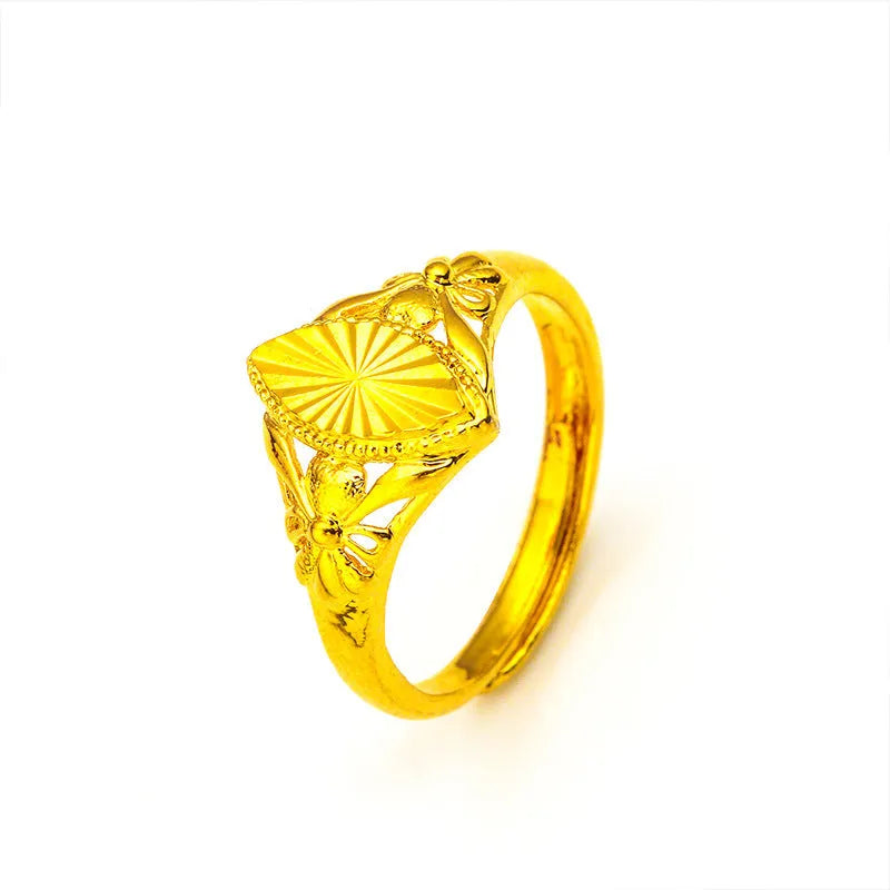 Gold coloured open diamond flower shape ring with geometric textured details on a brass base.