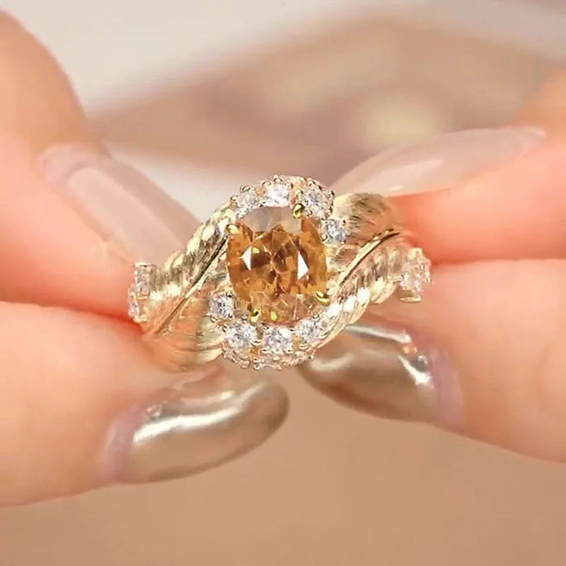Gold copper feather ring with embossed design and yellow zircon stone in geometric setting