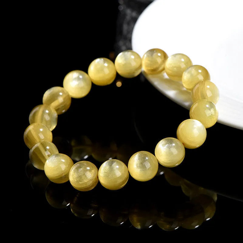 Polished natural mica round beads bracelet in yellow Lepidolite colour on flat surface