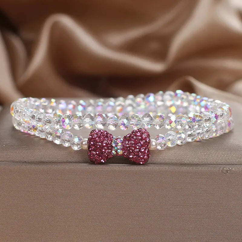 Double ring crystal bracelet with pearl and rhinestone accents on light background