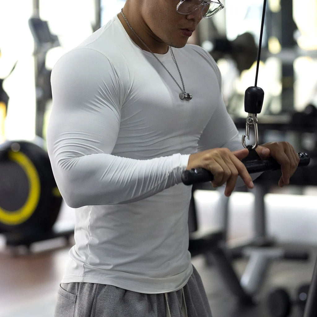 Men's long sleeve black fitness tights in slim fit for running and training.