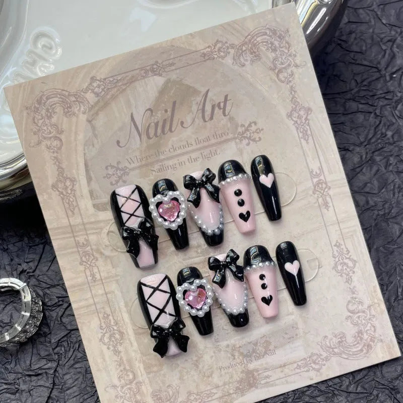 Black and pink heart hand-painted artificial nail set with cat's eye design in four sizes