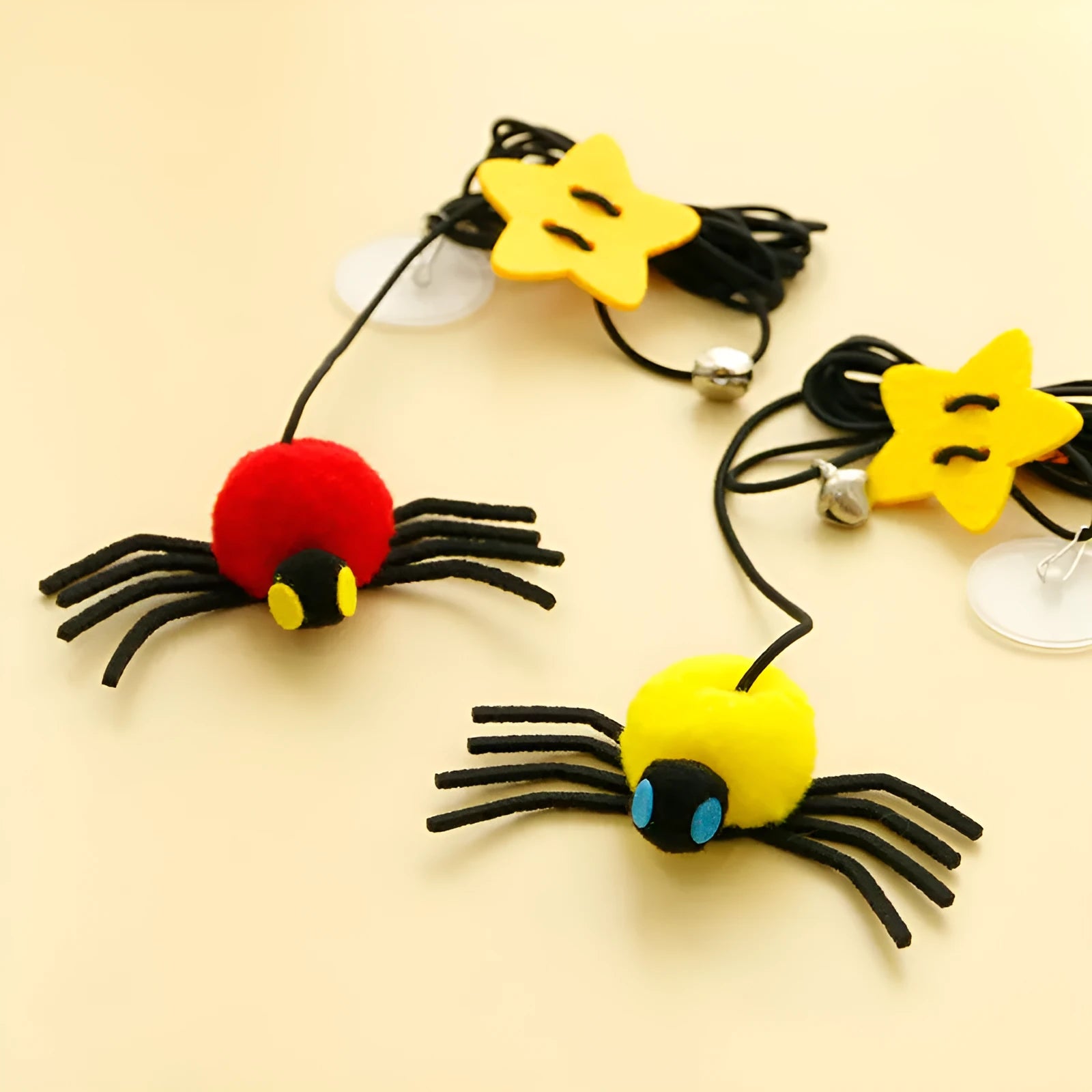 Red cat hanging toy with feather stick and bell spider on elastic rope mounted to door
