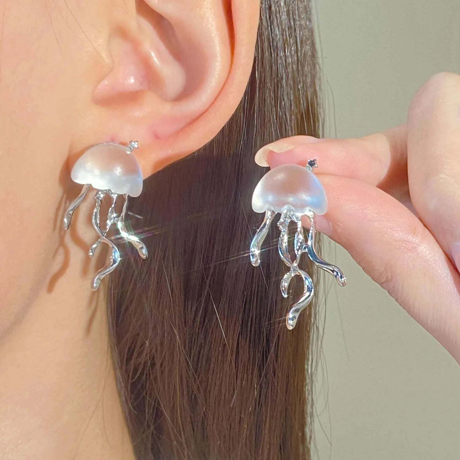 Frosted jellyfish pendant necklace and earrings in multiple colour options on a white background